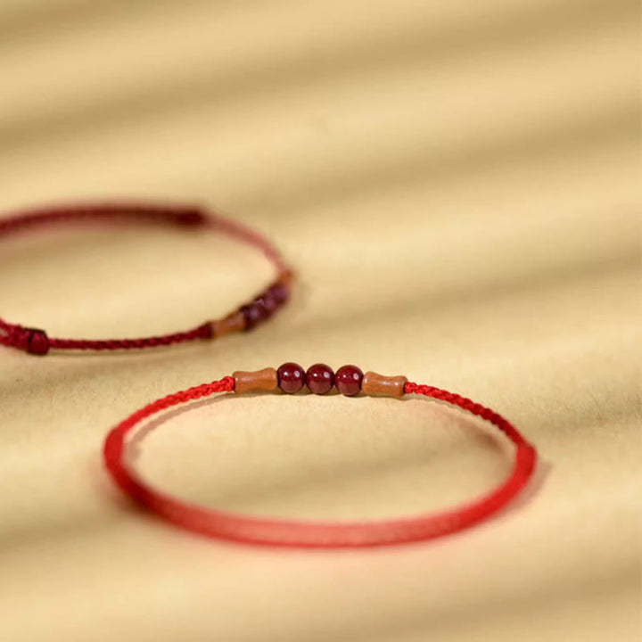 Bransoletka z Buddha Stones , koralików z cynobru, drewna brzoskwiniowego, sznurka błogosławieństwa