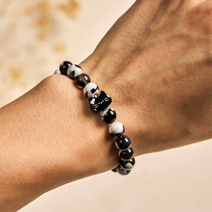 Bransoletka Buddha Stones z czarno-białego kota i ognistego agatu dodająca pewności siebie - image 3