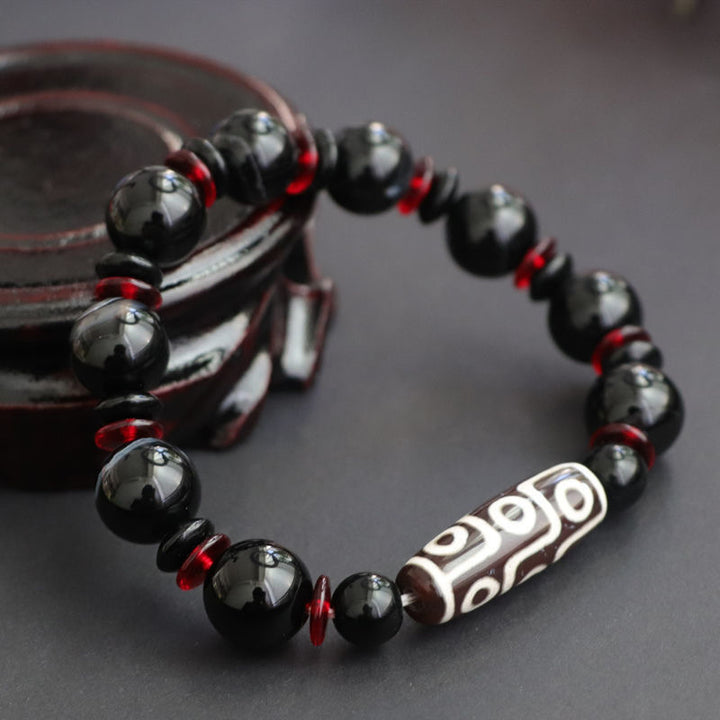 Bransoletka z Buddha Stones z czarnego onyksu i dziewięcioocznych koralików Dzi, chroniąca bogactwo