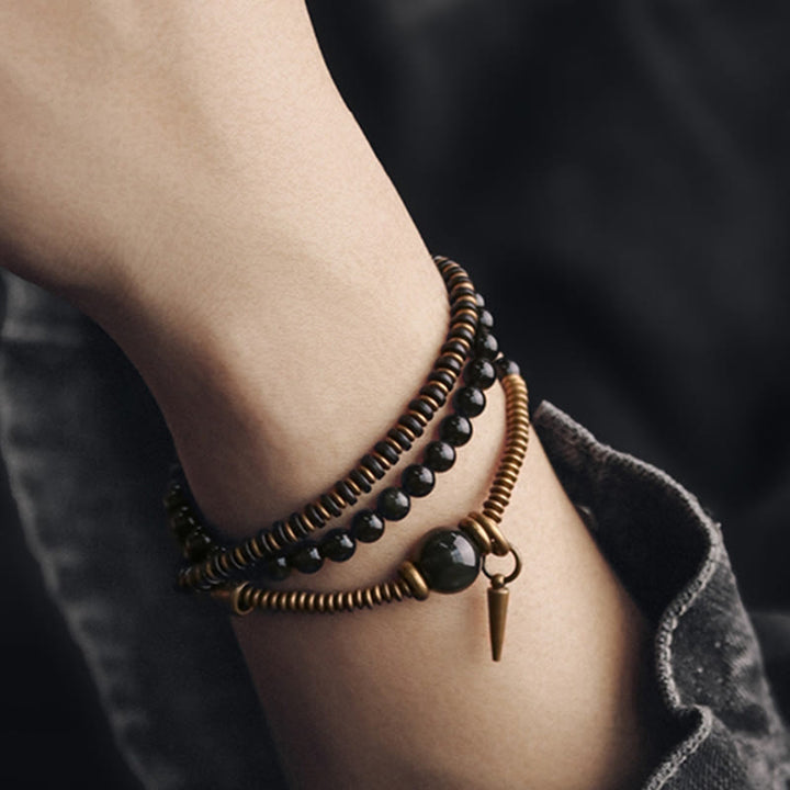 Bransoletka lecznicza z Buddha Stones, tęczowym obsydianem, drewnem hebanowym i miedzią, potrójnie owinięta