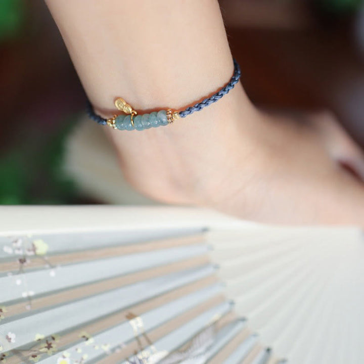 Bransoletka warkoczowa z naturalnego jadeitu i kwarcu rutylowego Fu Character Luck wykonana ze srebra próby 925