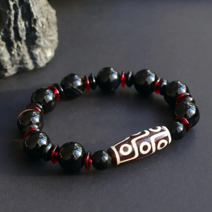 Bransoletka z Buddha Stones z czarnego onyksu i dziewięcioocznych koralików Dzi, chroniąca bogactwo