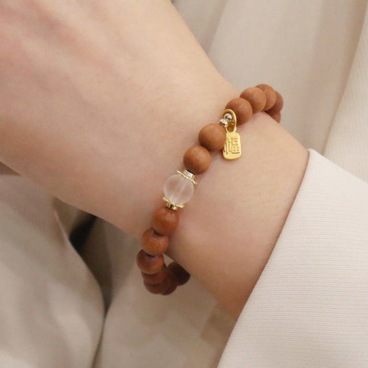 Bransoletka ochronna z Buddha Stones, sandałowym drzewem i kocim okiem Fu Character Charm