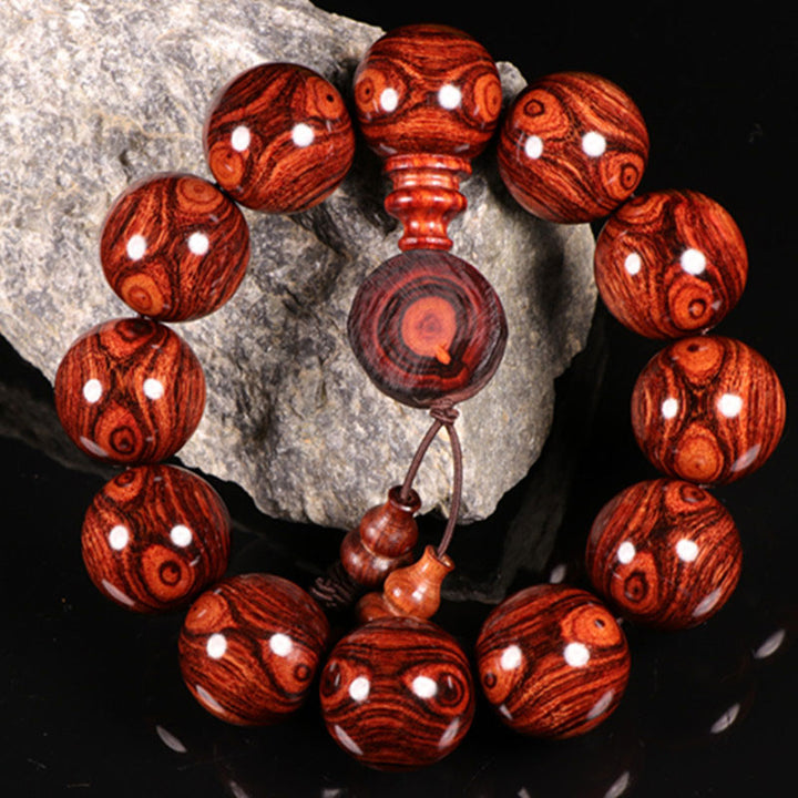 Bransoletka z ciepłego drewna palisandrowego z Buddha Stones (losowy typ)