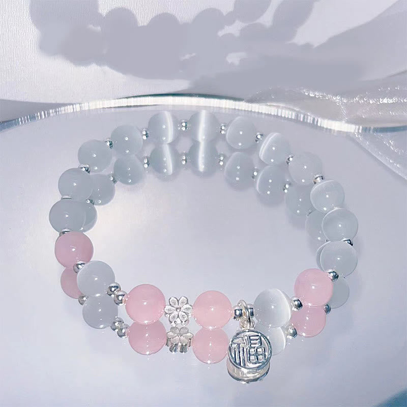 Bransoletka wspierająca z Buddha Stones, kryształem kociego oka i brzoskwiniowym dzwonkiem Fu Character Charm