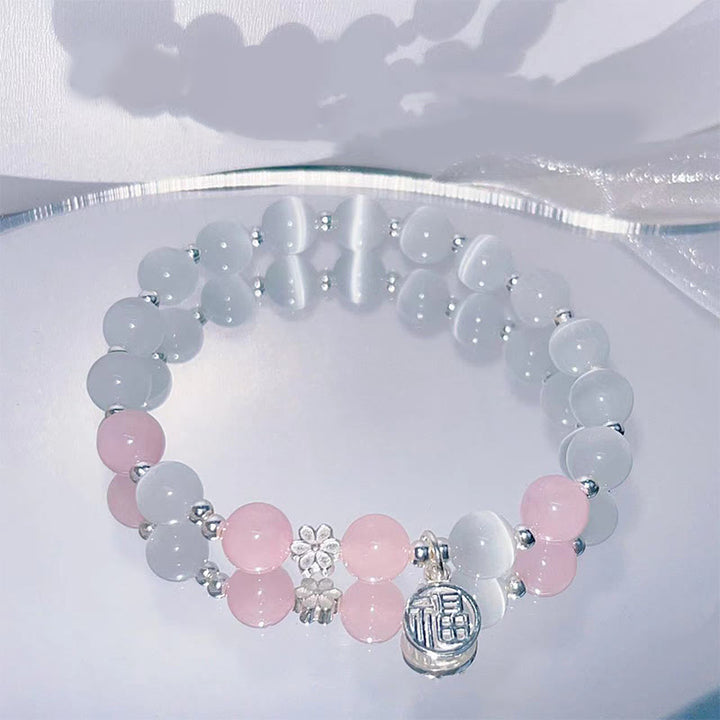 Bransoletka wspierająca z Buddha Stones, kryształem kociego oka i brzoskwiniowym dzwonkiem Fu Character Charm