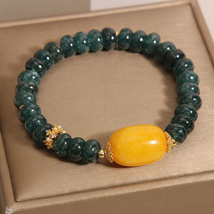 Bransoletka z Buddha Stones, zielonych jadeitowych koralików Abacus i topazu, z której można uzyskać szczęście