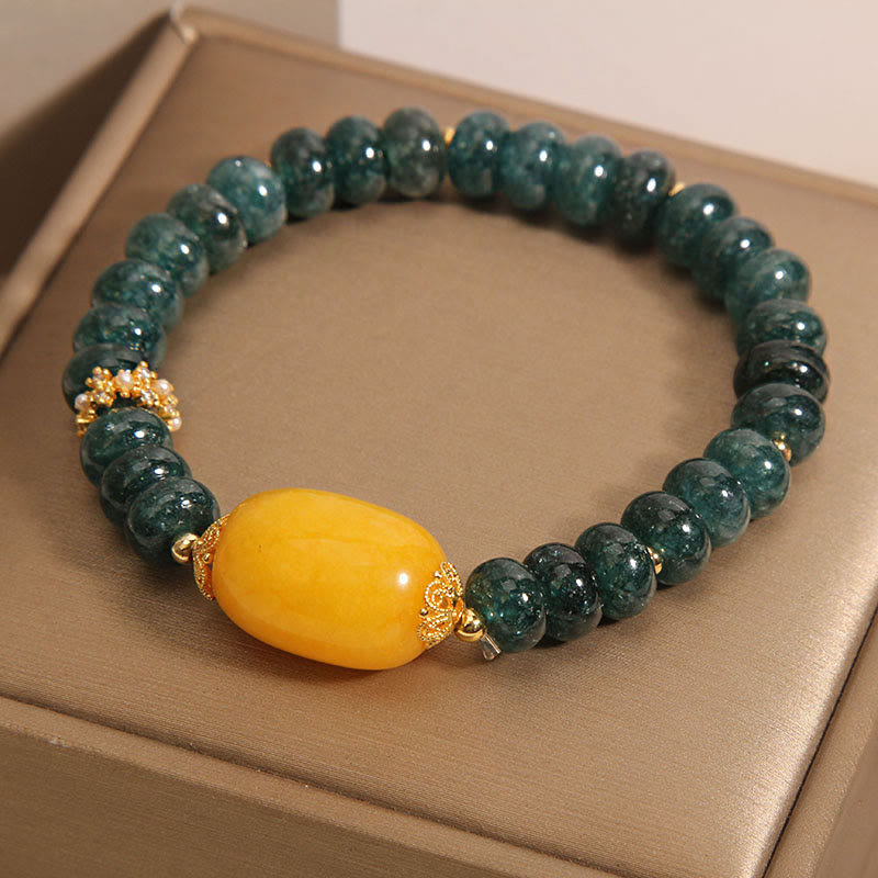 Bransoletka z Buddha Stones, zielonych jadeitowych koralików Abacus i topazu, z której można uzyskać szczęście