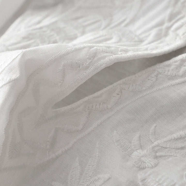 Letnia sukienka midi z haftowanymi liśćmi i kwiatami Buddha Stones w kolorze białym, z krótkim rękawem i dekoltem w serek i kieszeniami - image 7