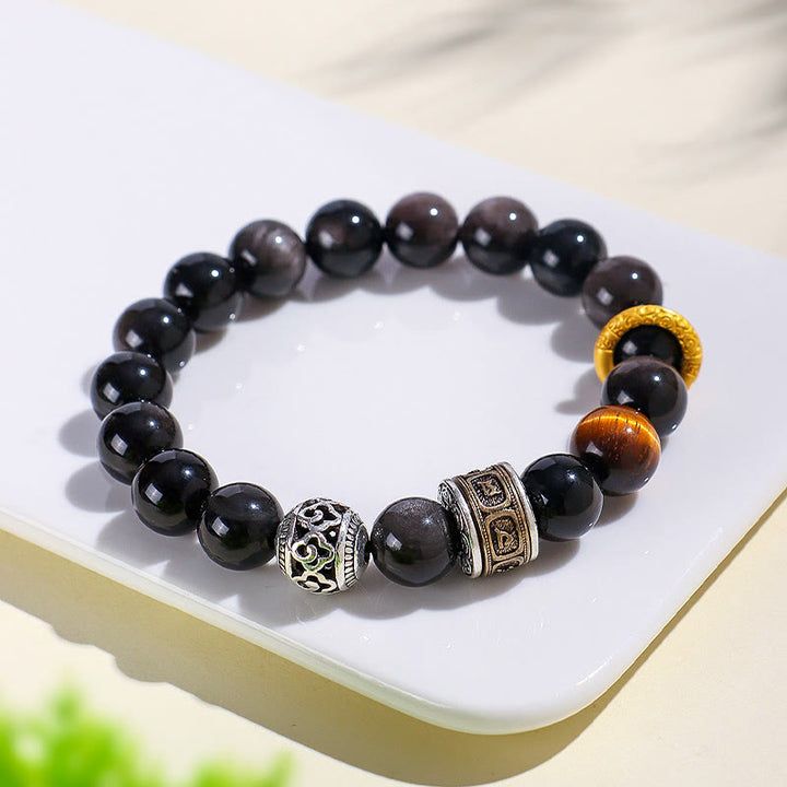 Bransoletka ochronna z Buddha Stones w kolorze srebrnym, obsydianem i tygrysim okiem Om Mani Padme Hum