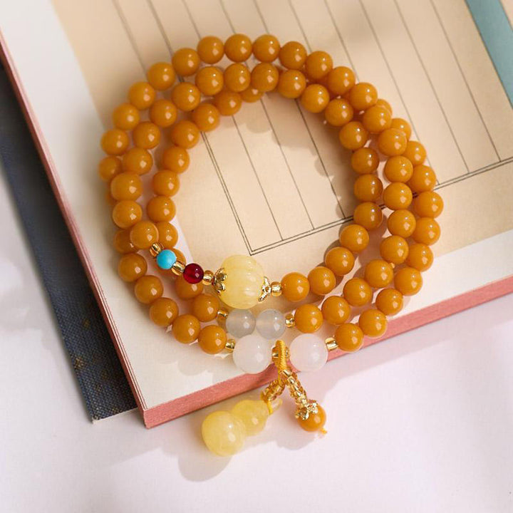 Bransoletka wielowarstwowa z bursztynu i tykwy Buddha Stones dodająca pewności siebie - Bursztyn 6 mm (obwód nadgarstka: 14-16 cm) - image 10