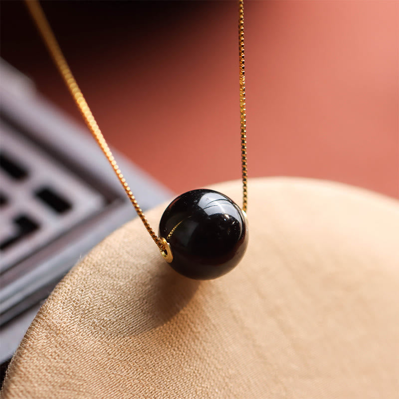 Naszyjnik z wisiorkiem "Buddha Stones" ze srebra próby 925 i bursztynowych koralików, z motywem skupienia i pewności siebie - Bursztyn i srebro próby 925 - image 0