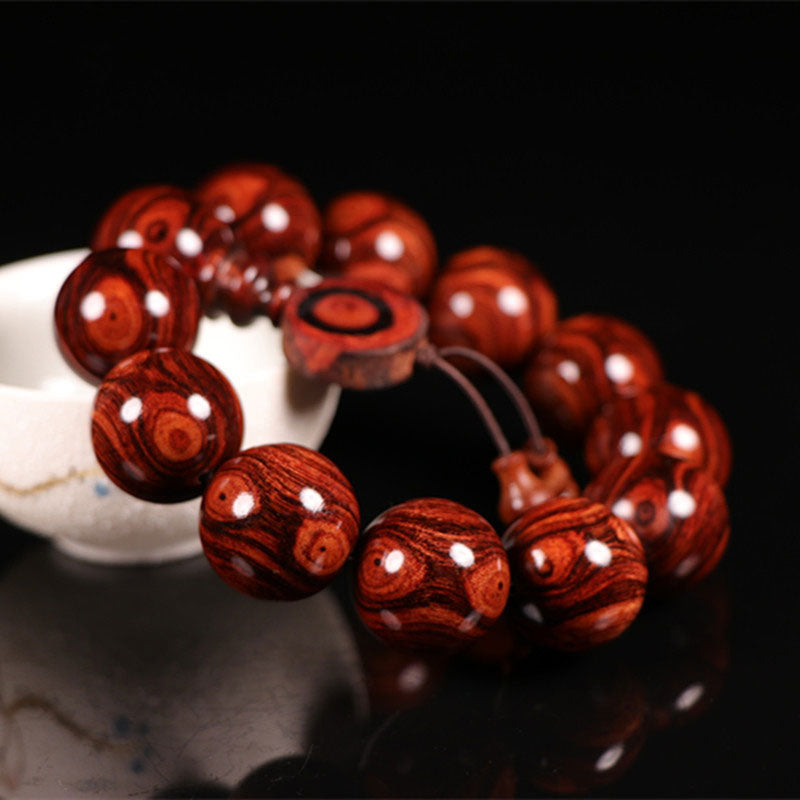 Bransoletka z ciepłego drewna palisandrowego z Buddha Stones (losowy typ)