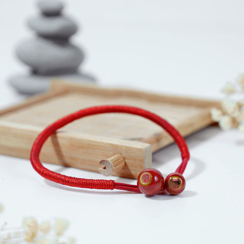 Bransoletka ceramiczna z czerwonymi sznurkami i Buddha Stones FengShui - image 1