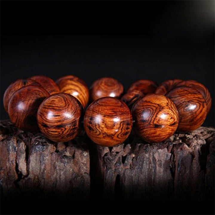 Bransoletka z ciepłego drewna palisandrowego z Buddha Stones (losowy typ)