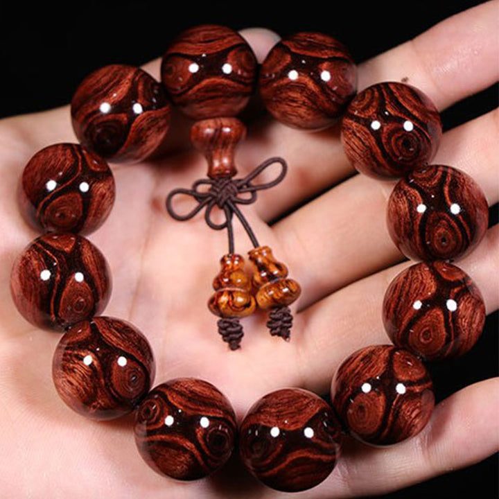 Bransoletka z ciepłego drewna palisandrowego z Buddha Stones (losowy typ)