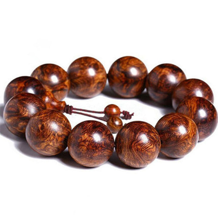 Bransoletka z ciepłego drewna palisandrowego z Buddha Stones (losowy typ)