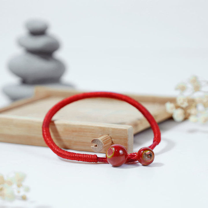 Bransoletka ceramiczna z czerwonymi sznurkami i Buddha Stones FengShui - image 2