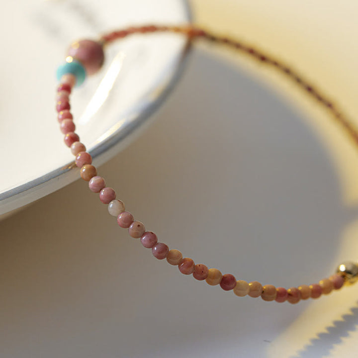 Bransoletka z naturalnego rodonitu i łańcuszka energetycznego z Buddha Stones 14K pozłacana