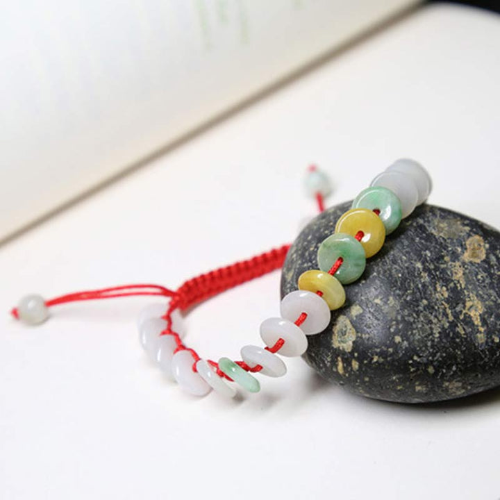 Bransoletka z okrągłym jadeitem i czerwonymi sznurkami Buddha Stones